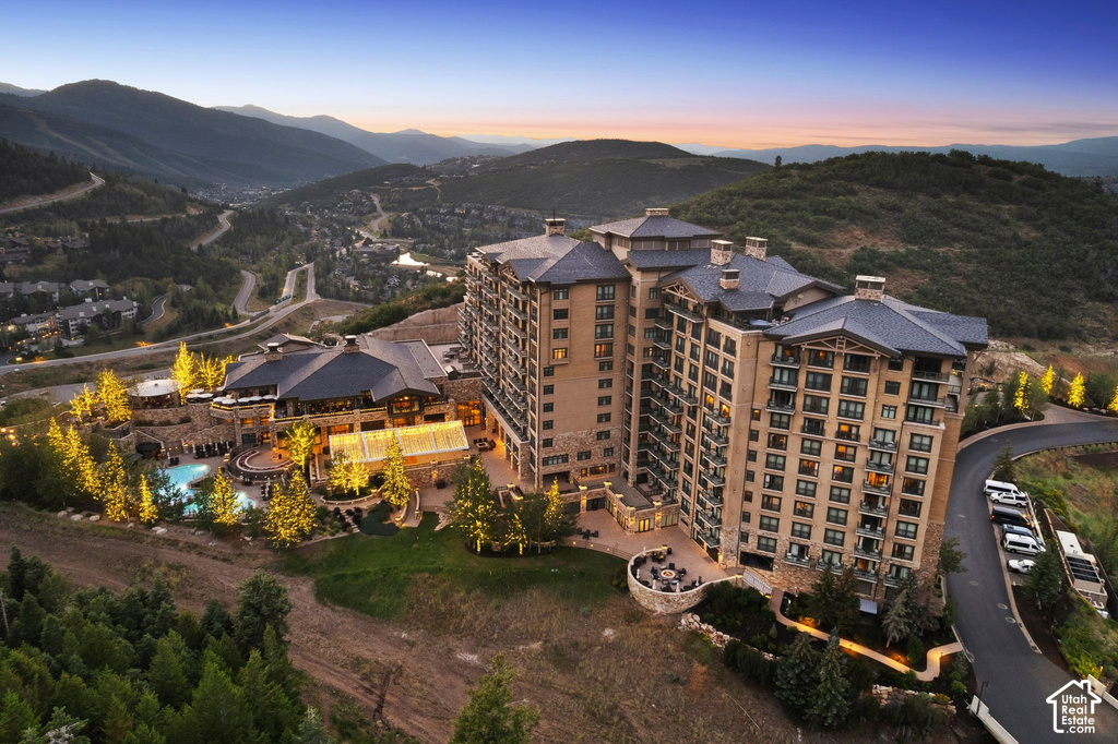 Expansive multi-story building featuring stacked balconies and a stone facade