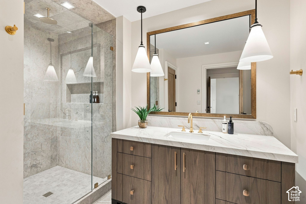 Modern bathroom featuring a wood-finish vanity with a white countertop and rectangular undermount sink