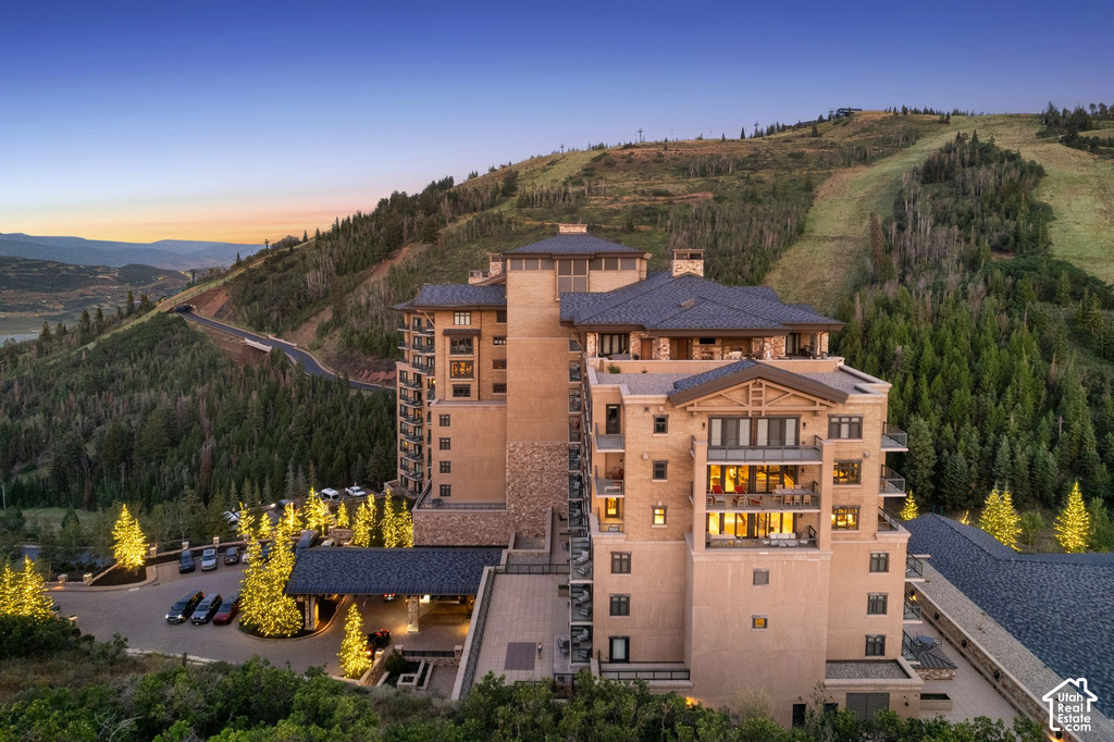 Striking contemporary architecture with warm terracotta-toned exterior, multi-level design, and expansive glazing