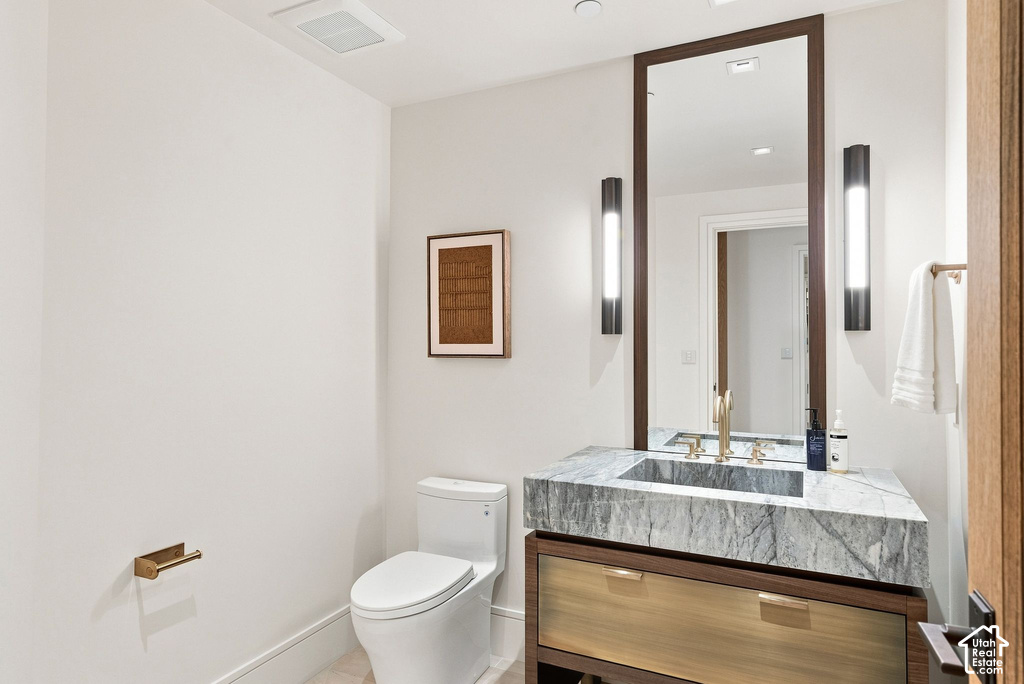 Modern bathroom featuring a floating wood-finish vanity with a marble-look countertop, rectangular vessel sink, and matte black wall-mounted sconces