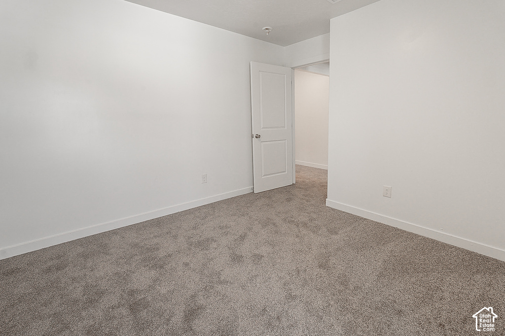 Room featuring neutral gray carpeting and white painted walls