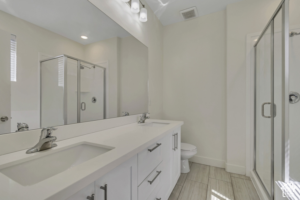 Dual vanity with integrated sinks, white cabinetry, and brushed nickel hardware