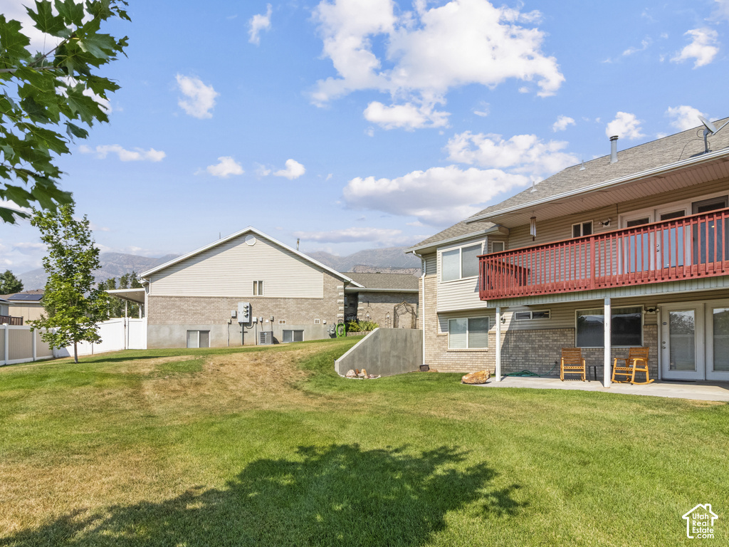 Expansive green lawn with a white vinyl fence