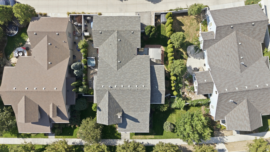 Aerial perspective showcasing properties with shingle roofs and established landscaping