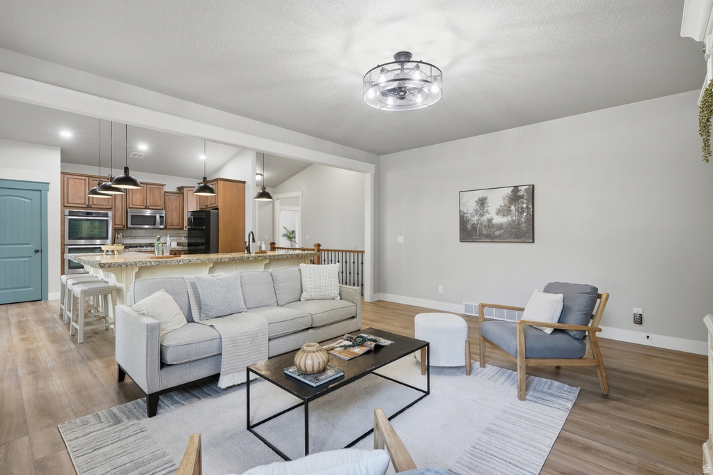 Open-concept living space with wood-finish flooring