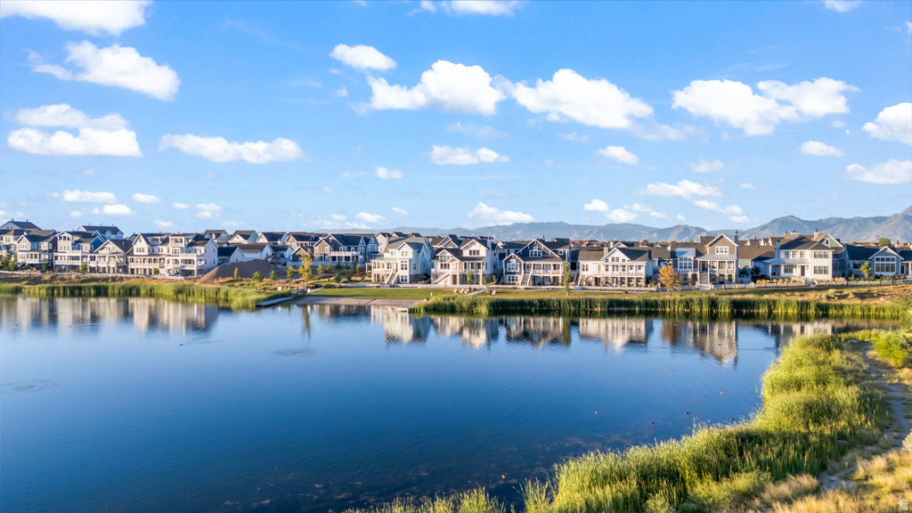 Waterfront properties with mature landscaping and mountain range backdrop