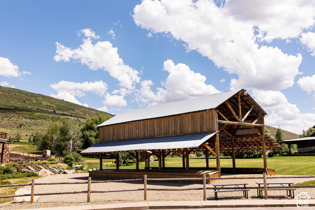 Rustic timber-frame structure with a metal roof and open-air covered space