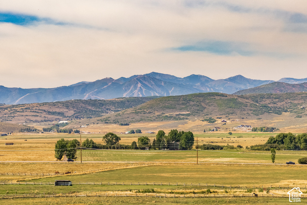Expansive mountain backdrop with distant peaks and rolling hills
