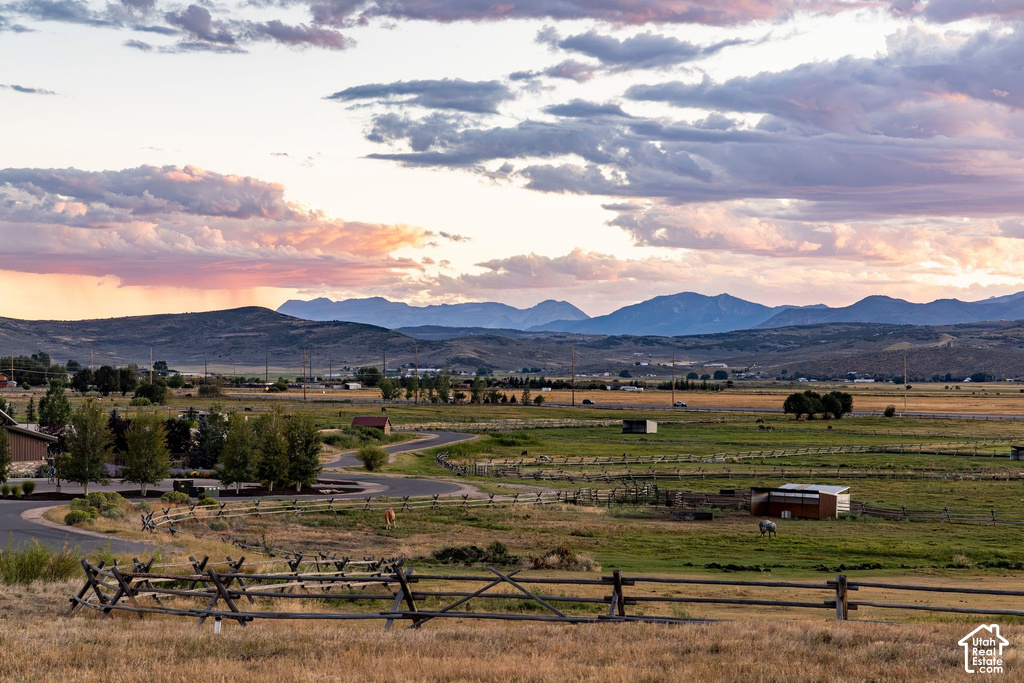 Expansive natural landscape with distant mountains and a winding paved road