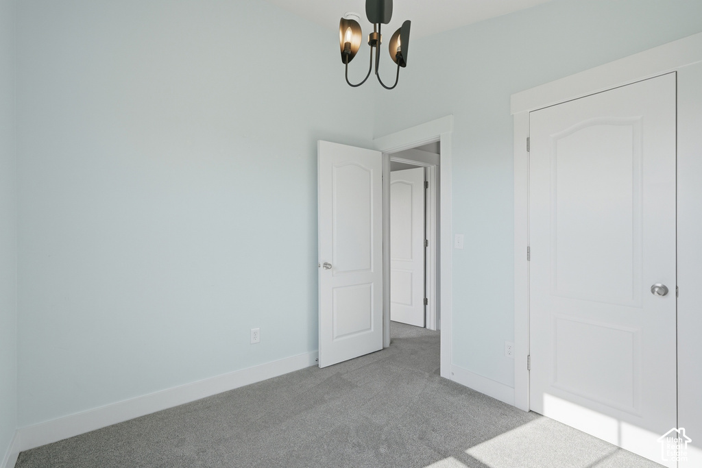 Light-toned walls, grey carpeting, and white paneled doors