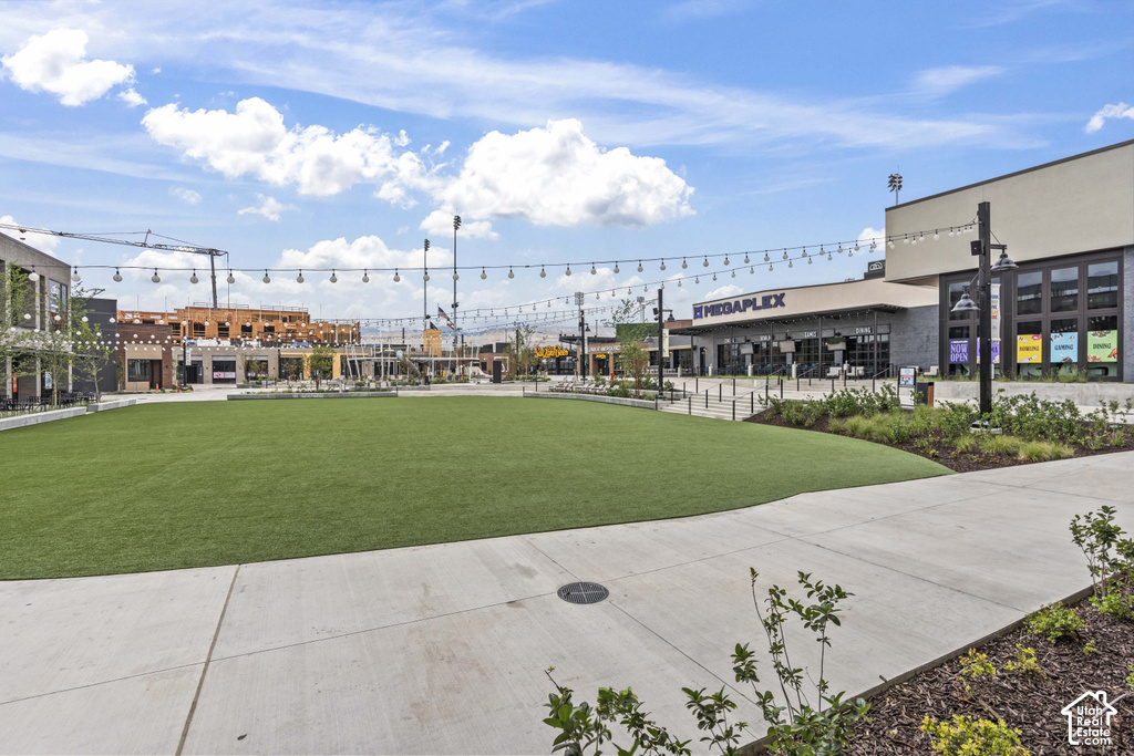 Expansive artificial turf lawn surrounded by concrete pathways and landscaping