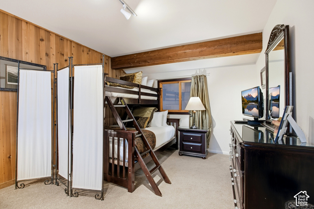 Wood-panel accent wall and exposed wood beam