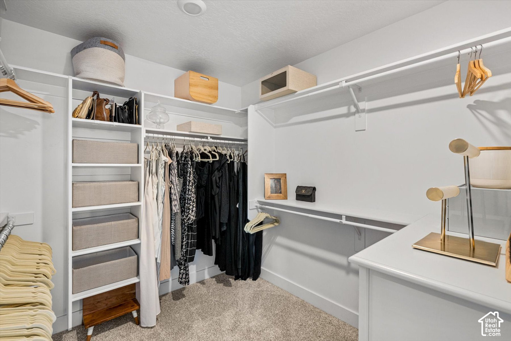 Custom closet system with white shelving, hanging rods, and built-in drawers