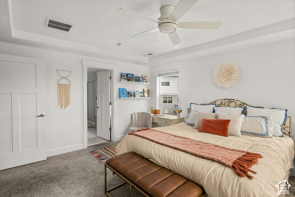 Tray ceiling with recessed lighting and a ceiling fan, plush carpet flooring, and a white paneled door