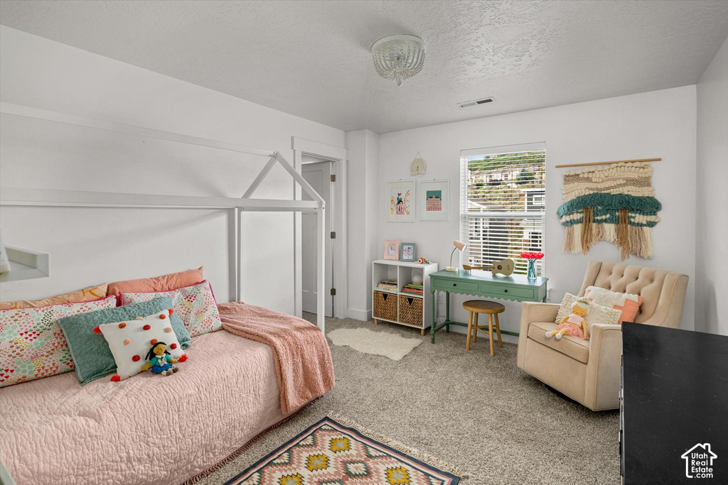 White painted walls, carpeted flooring, and a single window with blinds