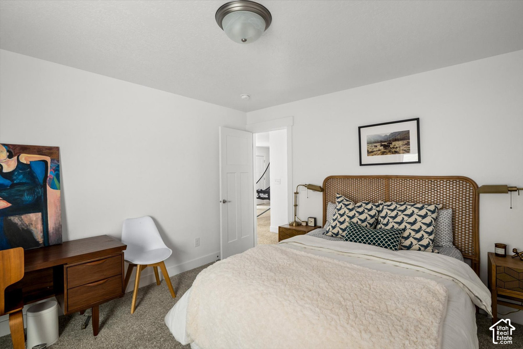 Neutral wall paint, carpet flooring, and a flush mount ceiling fixture