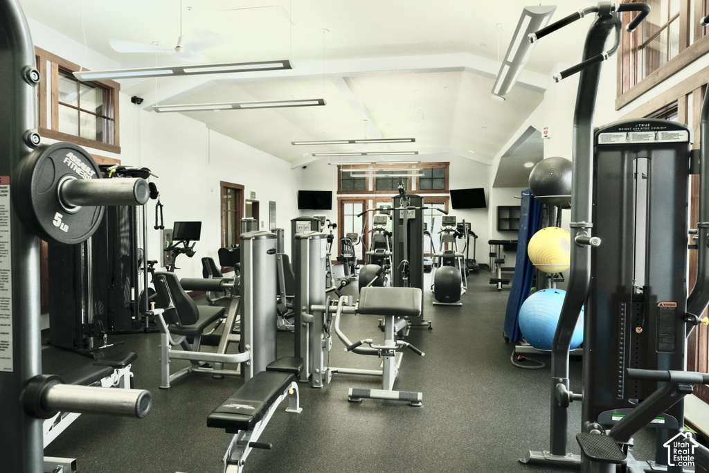 Gymnasium with vaulted ceilings, recessed lighting, and rubber flooring