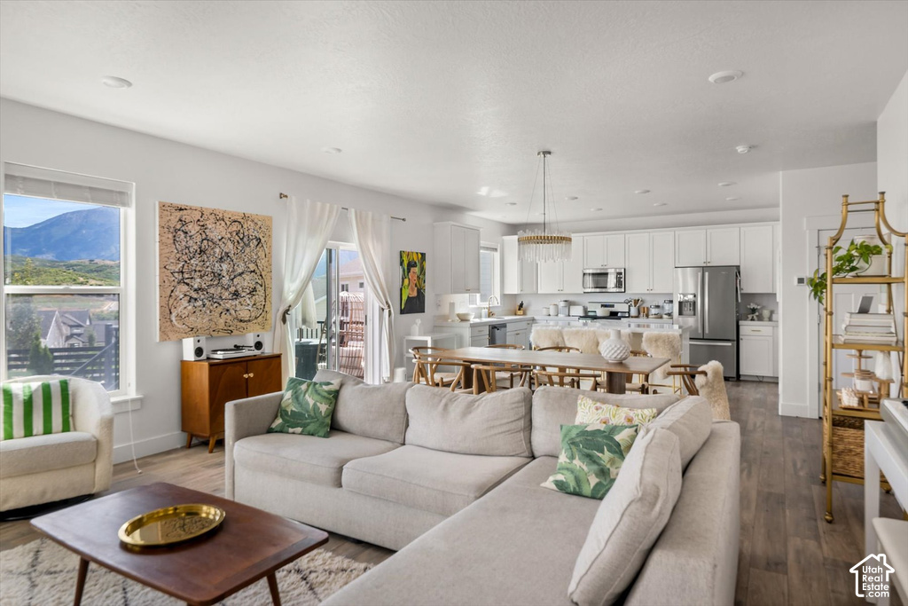 Open-concept living space featuring wood-finish flooring, recessed lighting, and a sliding glass door