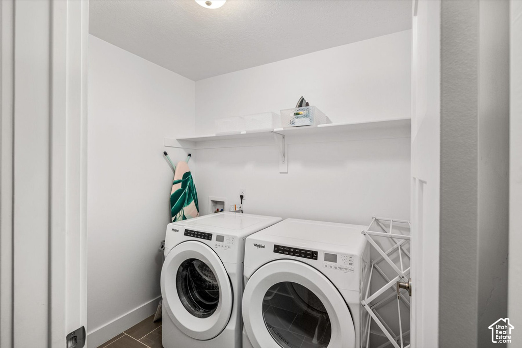 Dedicated laundry area featuring a shelf, overhead lighting, and tiled flooring
