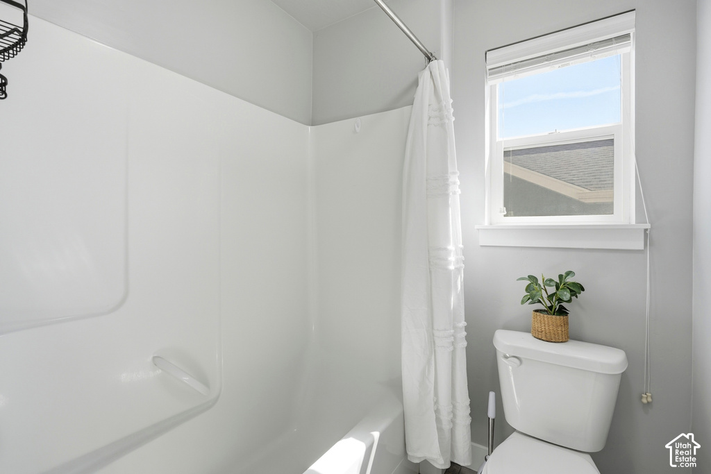 White shower-tub combination with a white shower curtain
