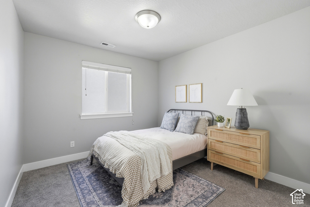 Recessed window with white trim, gray wall paint, and gray carpeting