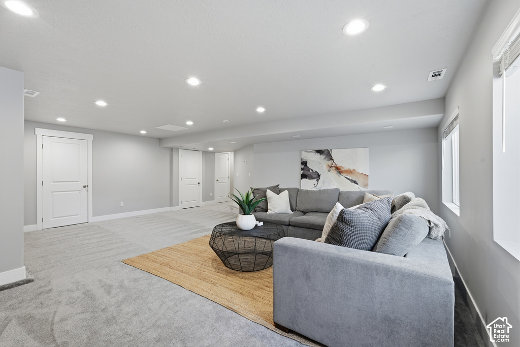 Recessed lighting, light gray wall finishes, light carpeting, white trim, and white two-panel interior doors