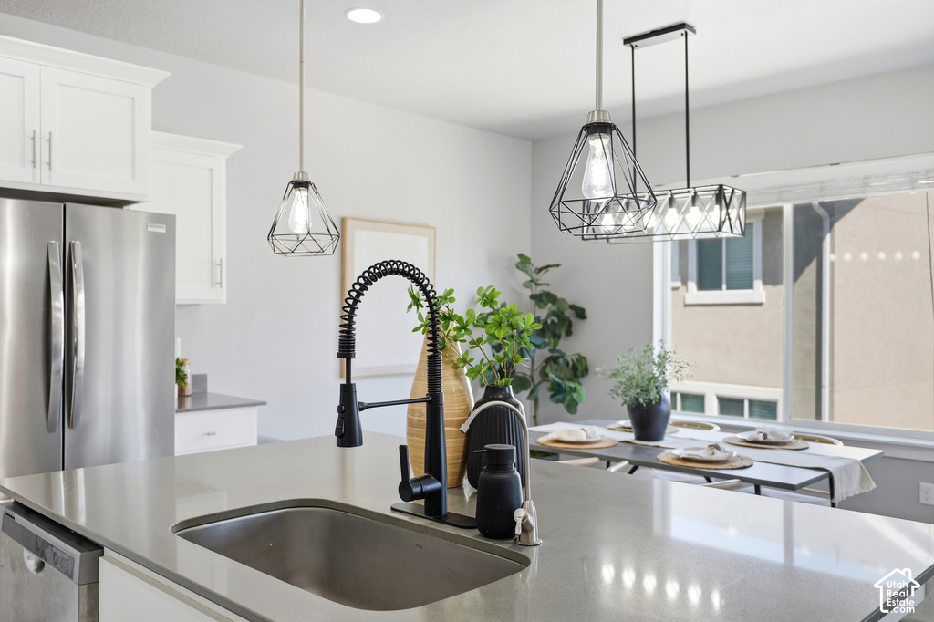 Kitchen island with an undermount sink and matte black pull-down faucet