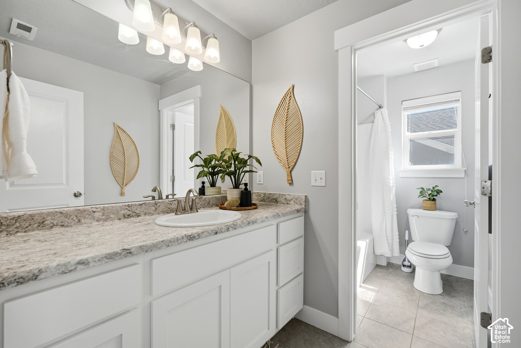 Vanity with stone-finish countertop, undermount sink, and brushed nickel faucet