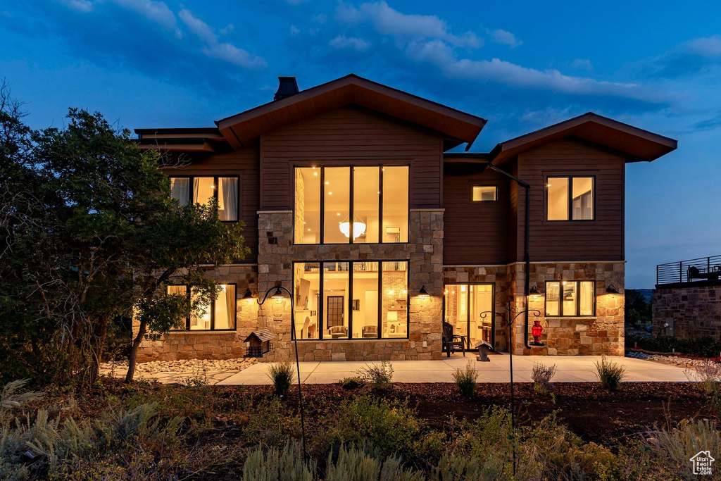 Stone and wood siding exterior with multiple large windows