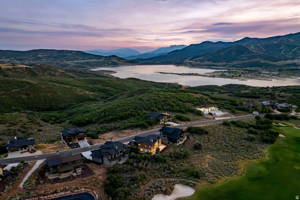Mountainous landscape with a prominent lake, surrounded by lush green hills
