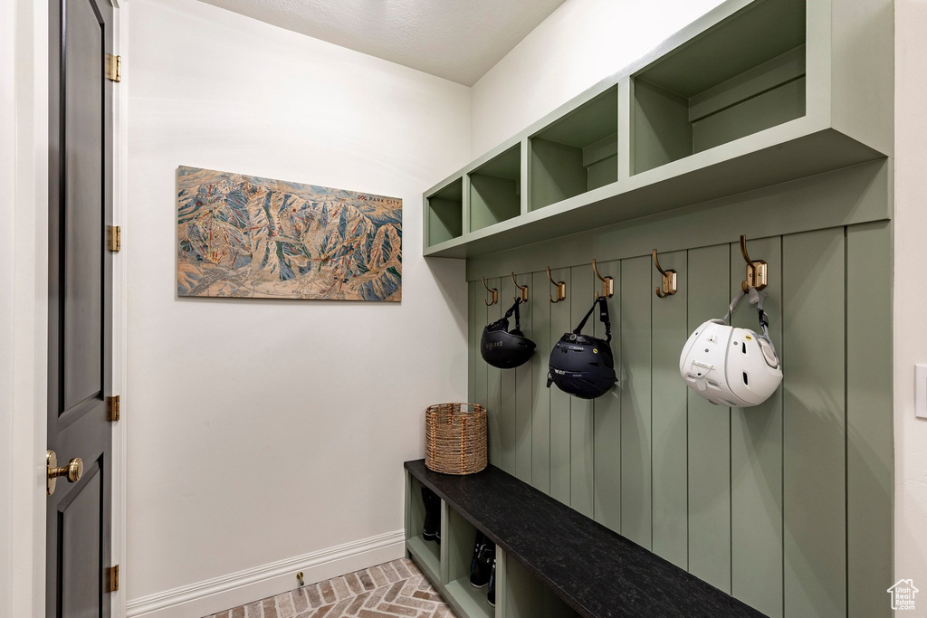 Built-in storage solutions featuring an integrated bench, coat hooks, and shelving