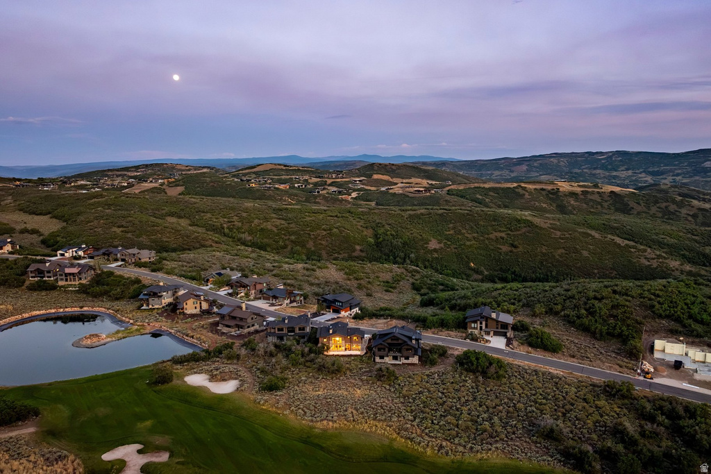 Lush, undulating topography with scattered residences and a tranquil pond feature