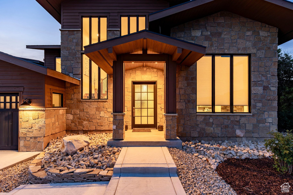 Stone and wood-clad exterior with a covered entry