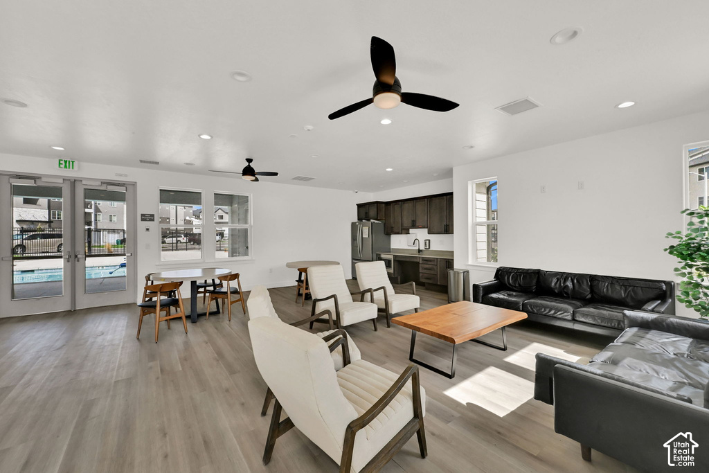 Open-concept common area featuring wood-finish flooring, recessed lighting, and ceiling fans
