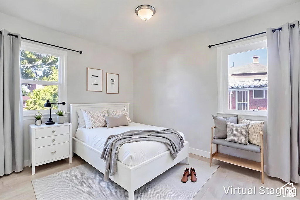 Dual windows with light gray curtains, a white three-drawer nightstand, and a flush mount ceiling light