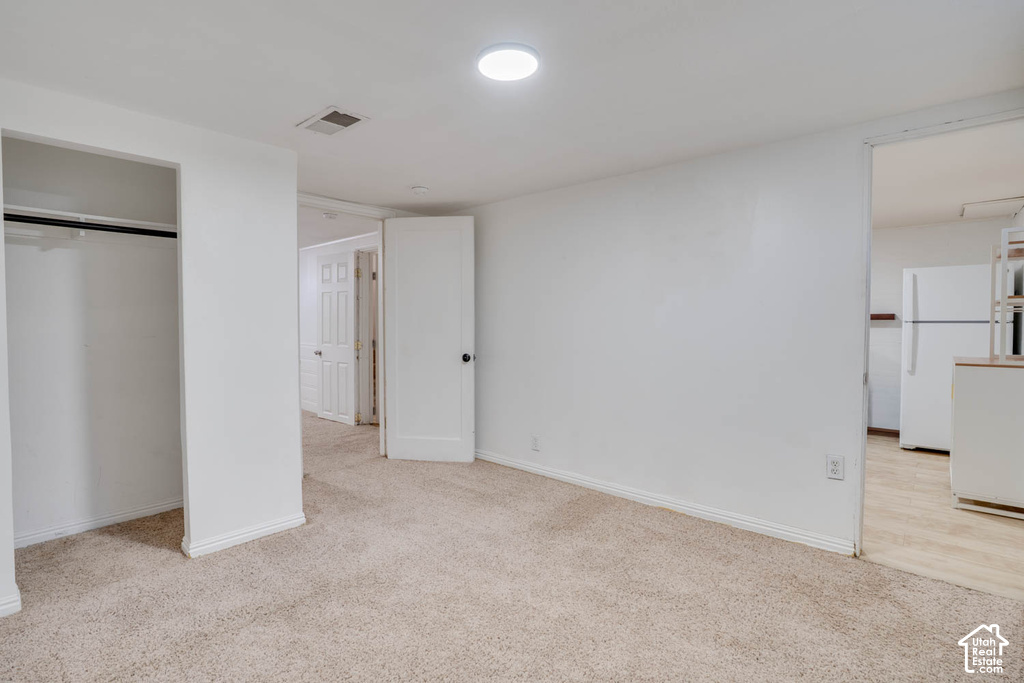 Recessed lighting, neutral carpeting, and an open closet