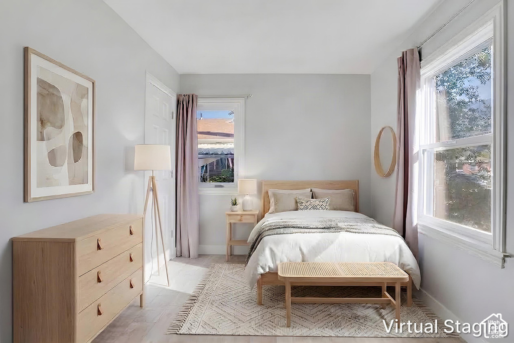 Wood-finish flooring with a neutral wall color, featuring a window and a white door
