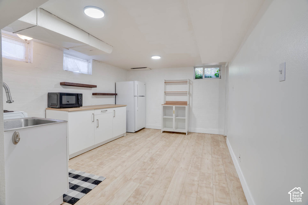 White walls and light wood-finish flooring