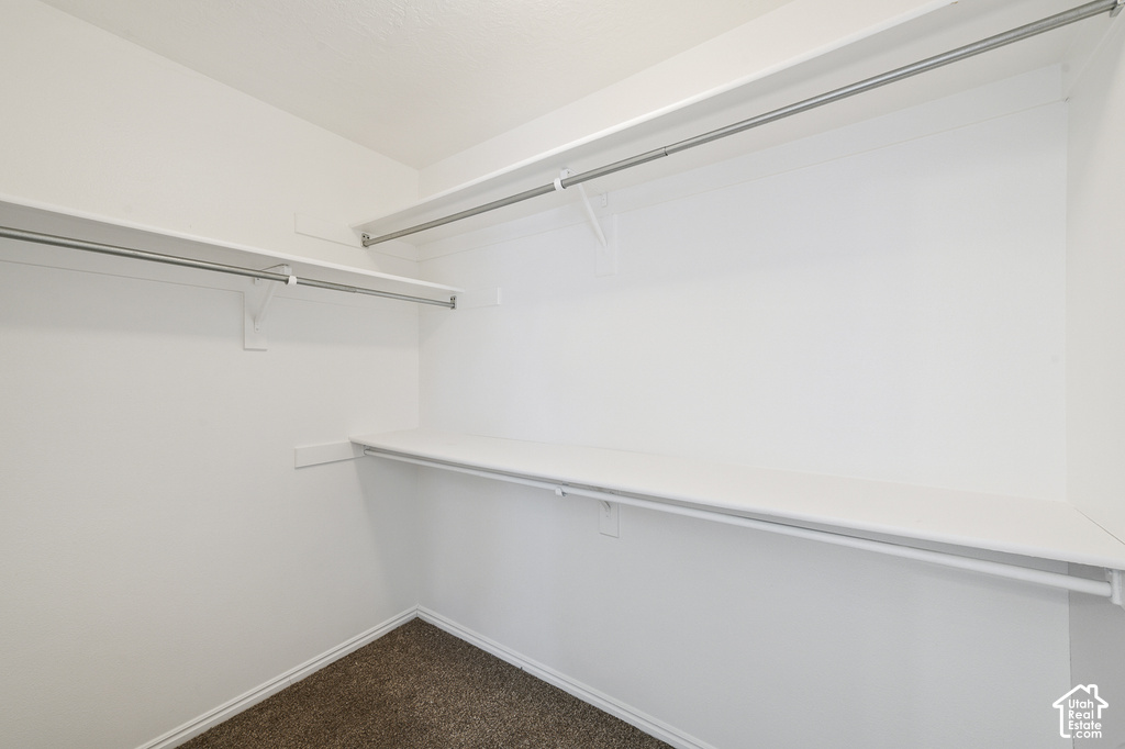 Wall-mounted shelving system with integrated hanging rods, providing ample storage