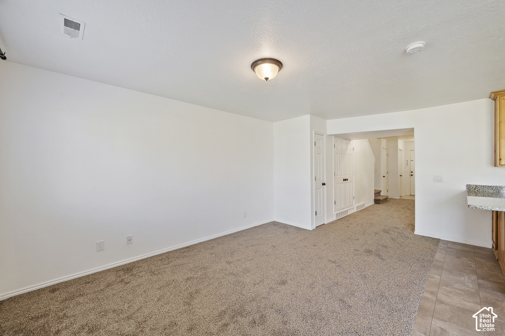 Light-toned wall finishes, neutral carpeting, and a built-in counter with a stone-finish surface
