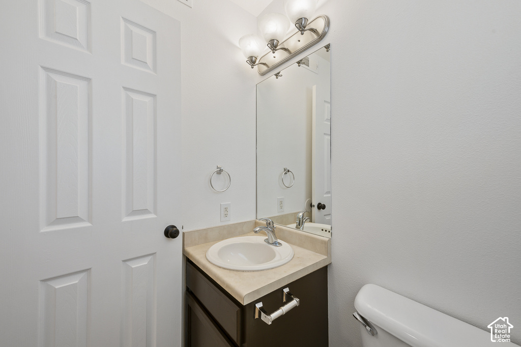 Vanity with an integrated sink, polished chrome faucet, and a wall-mounted mirror