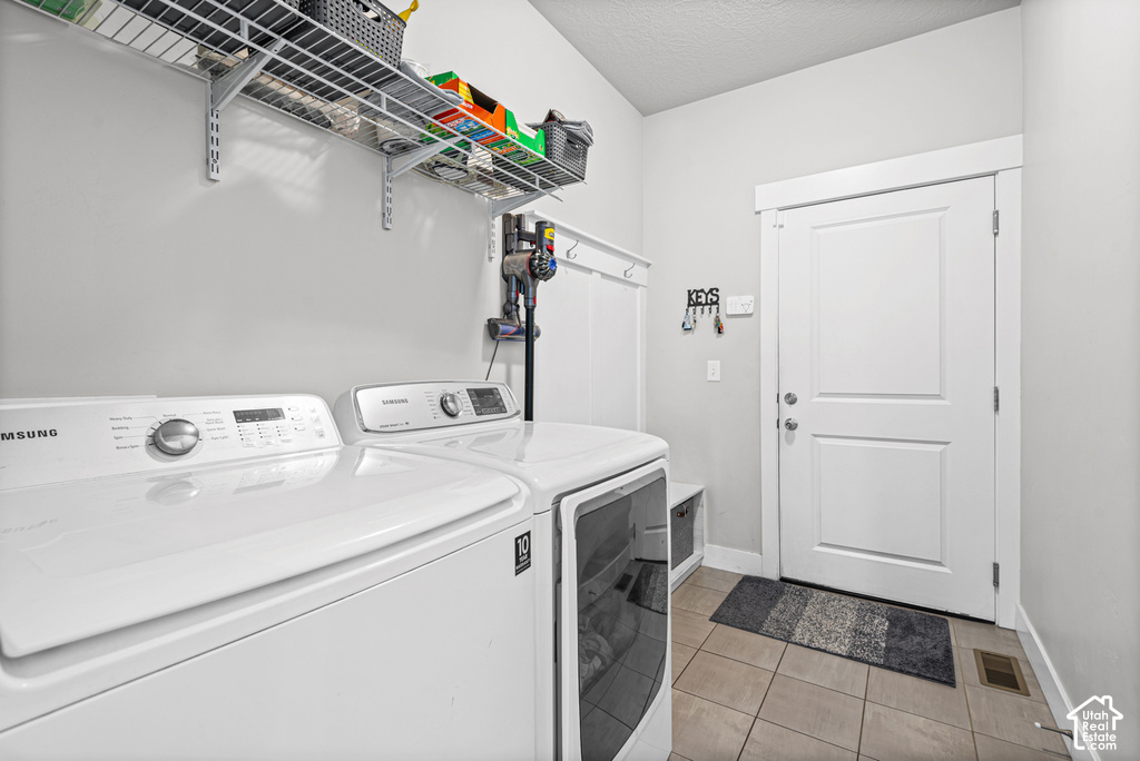 Tile flooring, white paneled door, built-in shelving, wall-mounted hooks, and wainscoting detail