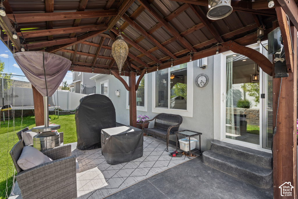 Covered outdoor patio with a wood-framed pergola and corrugated roof