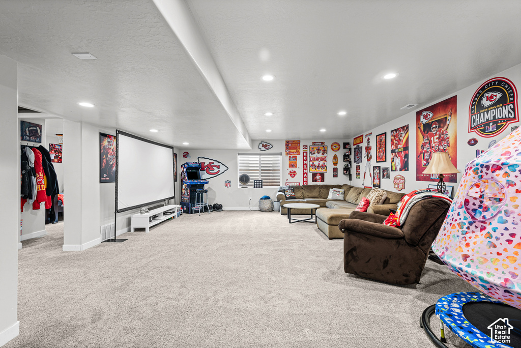Expansive room featuring plush carpeting, recessed lighting, a built-in shelving unit, and horizontal window blinds
