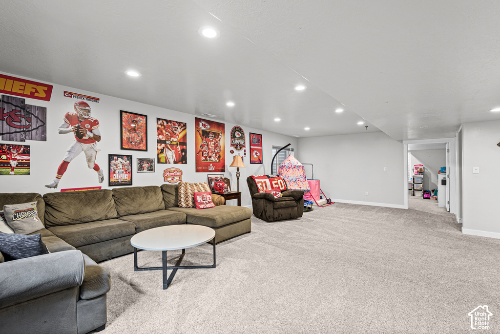 Recessed lighting, light gray wall paint, and gray carpeting