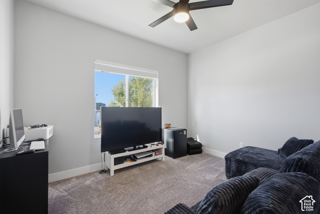 Carpet flooring, contemporary ceiling fan with integrated lighting, and a window providing natural illumination