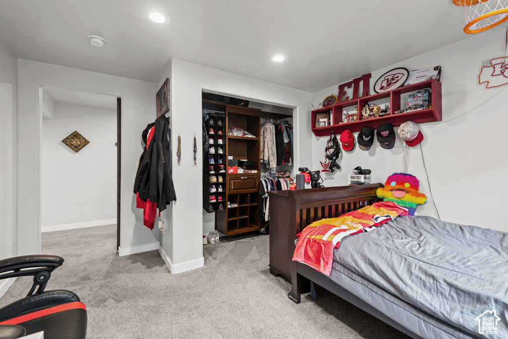 Recessed ceiling lighting, light gray wall paint, and gray carpeting