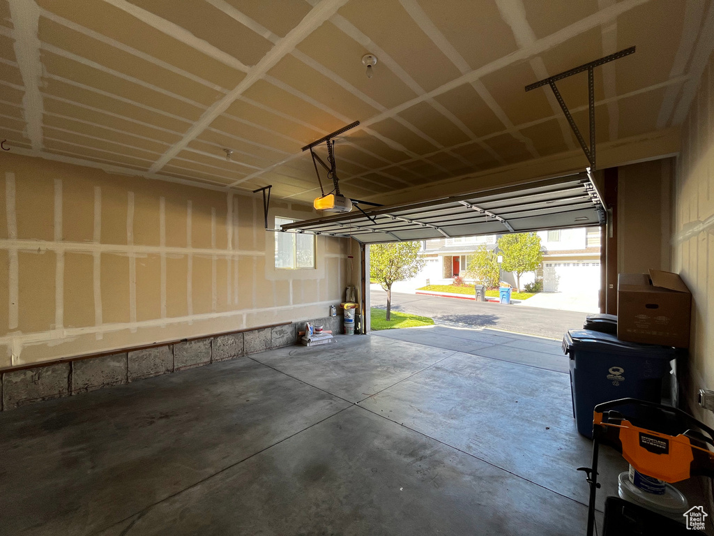Concrete flooring, window, and an automatic garage door opener