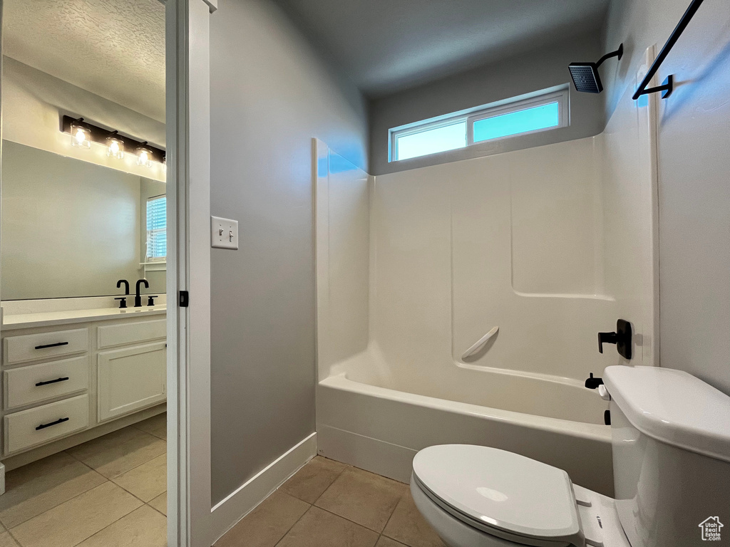 Bathroom featuring a white tub/shower combination, transom window, and matte black fixtures