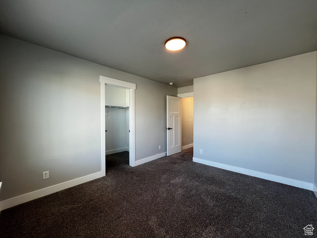 Carpeted flooring, light gray wall finish, white trim, recessed closet, and contemporary flush-mount lighting